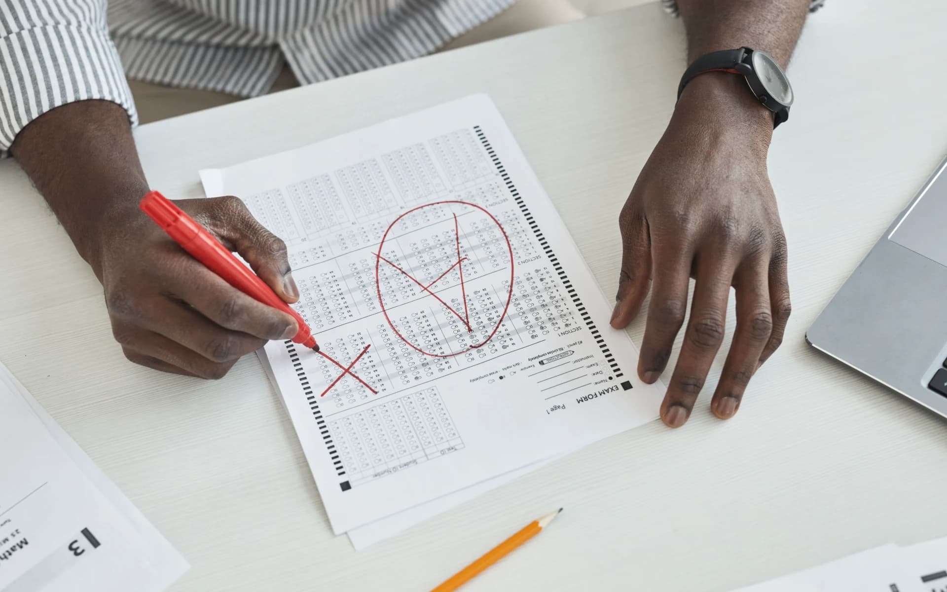A student working through coursework at a desk, checking their grades